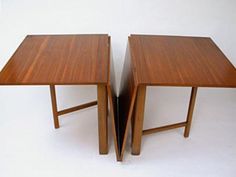 two wooden tables sitting side by side on a white surface