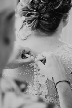 a woman in a wedding dress getting ready for her big day