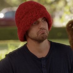 a man wearing a red hat and holding something in his hand