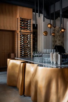 a bar with wine bottles and glasses on it