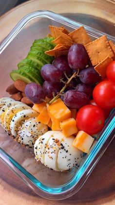 a plastic container filled with fruit and crackers