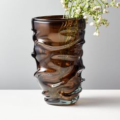 a vase with flowers in it sitting on a table