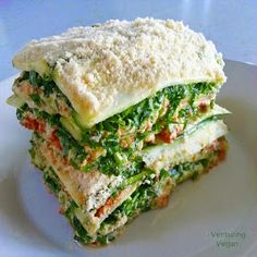 two sandwiches stacked on top of each other with cheese and veggie toppings