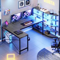 a desk with two monitors and a keyboard on it in a room that has blue lighting