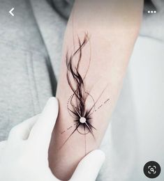 a woman's arm with a tattoo on it that has long hair coming out of it