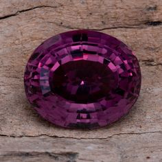 a purple diamond sitting on top of a wooden table