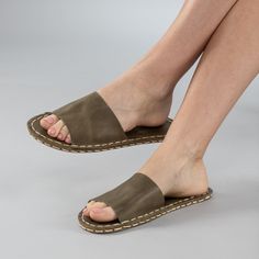 Introducing the Green Barefoot Slide Sandals - the perfect addition to your summer wardrobe. Handmade in Turkey with 100% natural materials, these sandals are crafted with a natural leather upper and a water buffalo leather sole, ensuring maximum comfort and breathability for your feet. With a wider toe box, your toes have enough room to spread and relax, promoting a more natural gait and posture. The "zero-drop" non-elevated heel helps maintain proper posture as well. Available in sizes ranging Natural Color Closed Toe Sandals With Leather Footbed, Beach Slip-on Slingback Sandals With Leather Sole, Closed Toe Leather Barefoot Sandals For Beach, Natural Closed Toe Sandals With Leather Footbed, Natural Open Toe Sandals With Stitched Sole, Natural Closed Toe Sandals With Stitched Sole, Leather Open Toe Barefoot Sandals For Beach, Leather Open-toe Barefoot Sandals For Beach, Natural Sandals With Stitched Sole And Round Toe