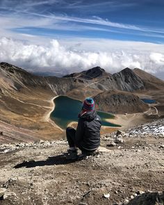 a person sitting on top of a mountain next to a lake with the words hiking tips, checklists and more