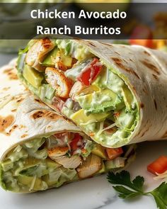 chicken avocado ranch burritos with lettuce and tomatoes on the side