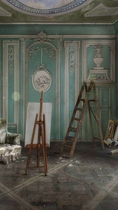 an empty room with easels and paintings on the wall