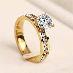 a gold ring with a diamond on the side