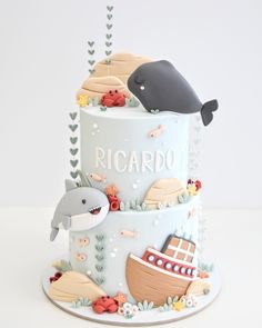 there is a birthday cake that looks like a boat and whale on it, with the name picardo