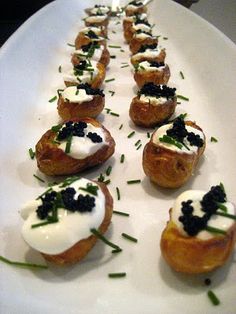 small appetizers are lined up on a white plate