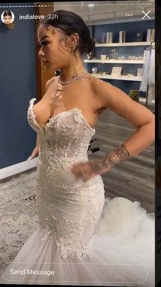 a woman in a wedding dress is taking a selfie with her cell phone while looking at the camera