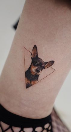 a small dog's head is shown on the side of a woman's leg