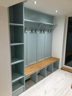 an empty room with several blue shelves and benches