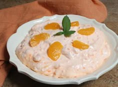 a white plate topped with oranges on top of a table