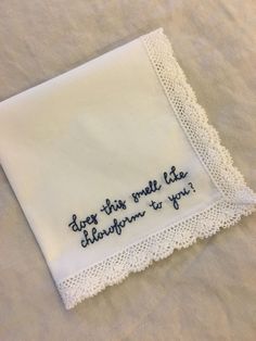 a white handkerchief with embroidered words on it