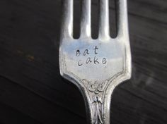 a fork with the words eat cake written on it