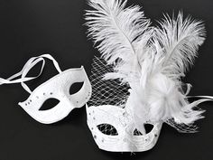 Simplistic for the man in the white rhinestones mask and chic for the woman in the white feather mask. The woman's fabricated texture and lacing veil are destined to pop out at any event. This masquerade mask is great for any occasion. White Formal Masquerade Mask For Carnival, Elegant White Eye Mask, Elegant White Masquerade Mask For Weddings, Elegant White Wedding Masquerade Mask, White Wedding Eye Mask, White Eye Mask For Wedding, White Feather Mask, Rhinestones Mask, Blue Masquerade Mask