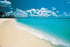 the beach is clear and blue with white sand