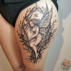 a woman's thigh with an angel tattoo on it