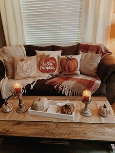 a living room filled with furniture and candles