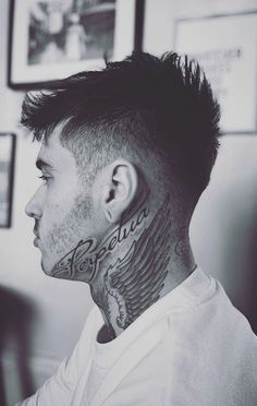 a man with tattoos on his face and neck