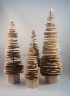 three small wooden christmas trees on top of each other