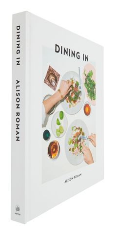 a cookbook with the title dining in, written by author and editor aaron roman