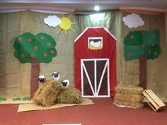 a stage set with hay bales and farm animals