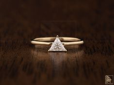 a diamond ring sitting on top of a wooden table