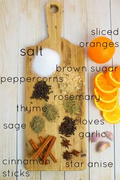 a cutting board with spices on it next to an orange slice and cinnamon sticks, salt, orange slices, peppercorns, sugar, turms, rosemary, thyme,