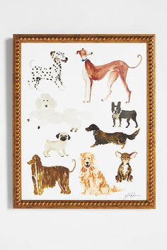 an art piece with dogs on it in a gold framed wooden frame against a white wall