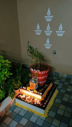 there are many plants and potted plants in the corner by the wall with raindrops on it