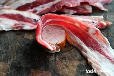 some bacon is laying on top of a cutting board