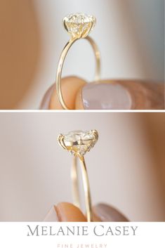 a close up of a person's hand holding a ring with a diamond on it