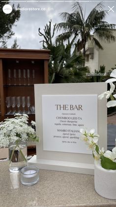 the bar is set up with flowers in vases