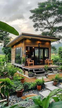 a small wooden house surrounded by greenery and trees