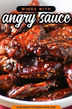 wings with angry sauce in a white bowl on a red tablecloth and text overlay