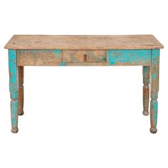 an old wooden table with blue paint on it