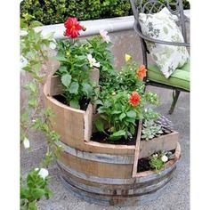 a wooden barrel filled with lots of flowers