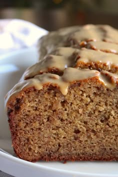 a close up of a loaf of cake on a plate with frosting and icing