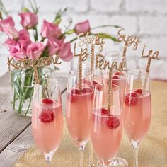 three champagne flutes with raspberries in them and the words happy birthday on top