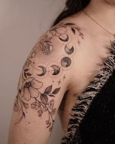 a woman's arm with flowers and moon tattoos on her left shoulder, while the other half is black and white