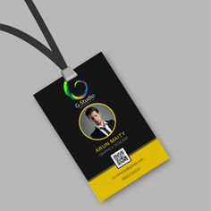 a black and yellow id card with an image of a man in a suit on it