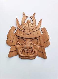 a wooden mask with an evil face on it