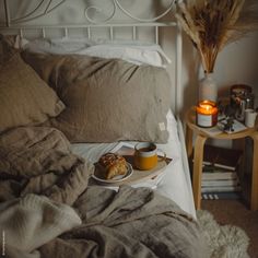 a bed with a tray of food on top of it