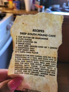 a person holding up a piece of paper with some writing on it that reads recipes deep south pound cake