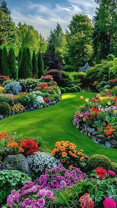 a lush green field filled with lots of flowers next to trees and grass covered ground